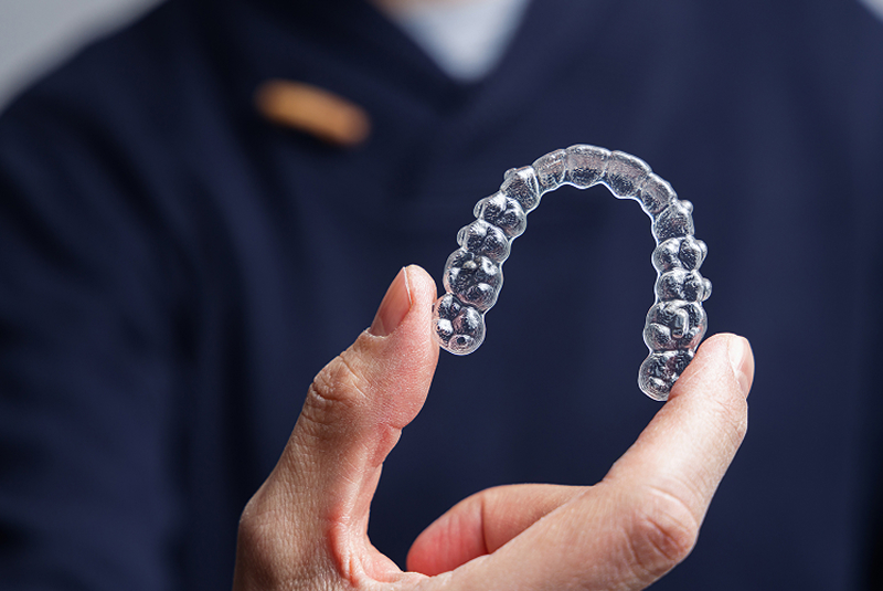 Clear aligner held in hands