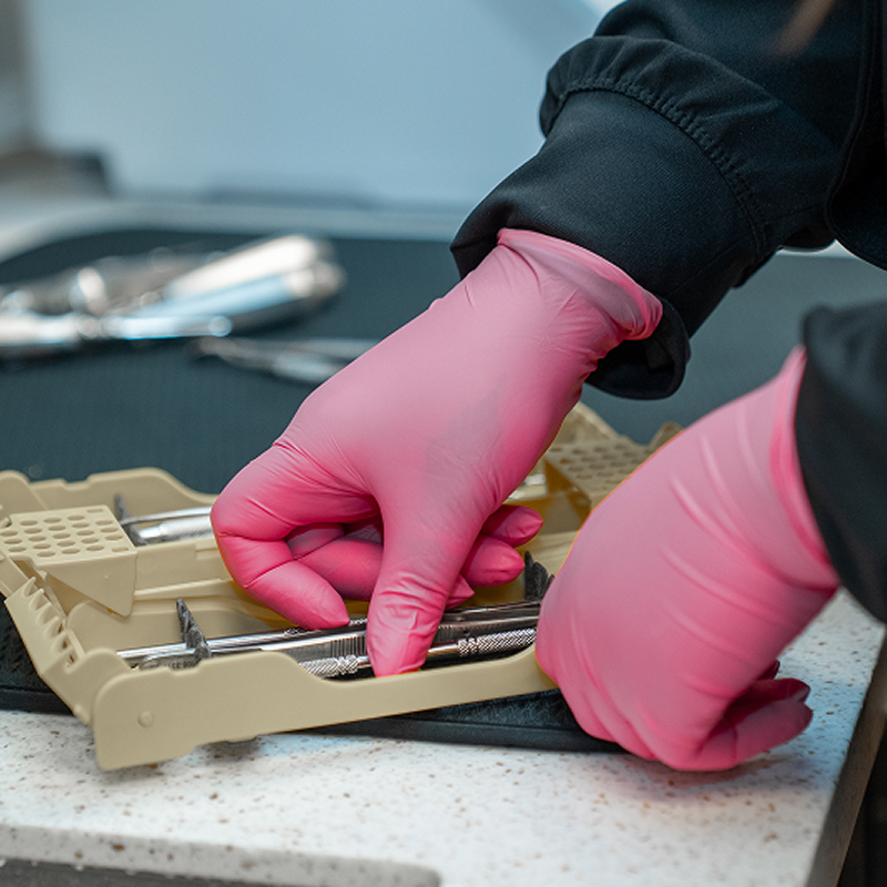 Dental assistant preparing treatment equipment sqaure