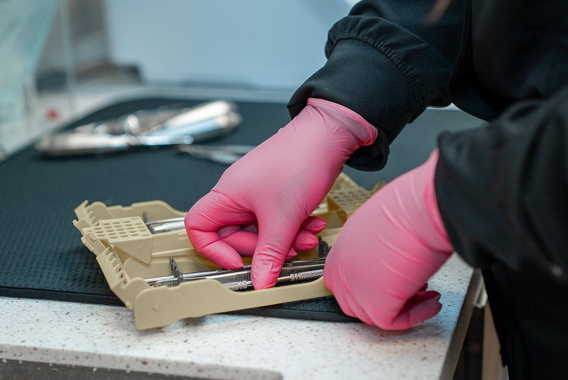 Dental assistant preparing treatment equipment