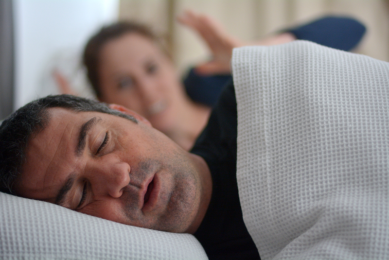 Man snoring and keeping partner awake