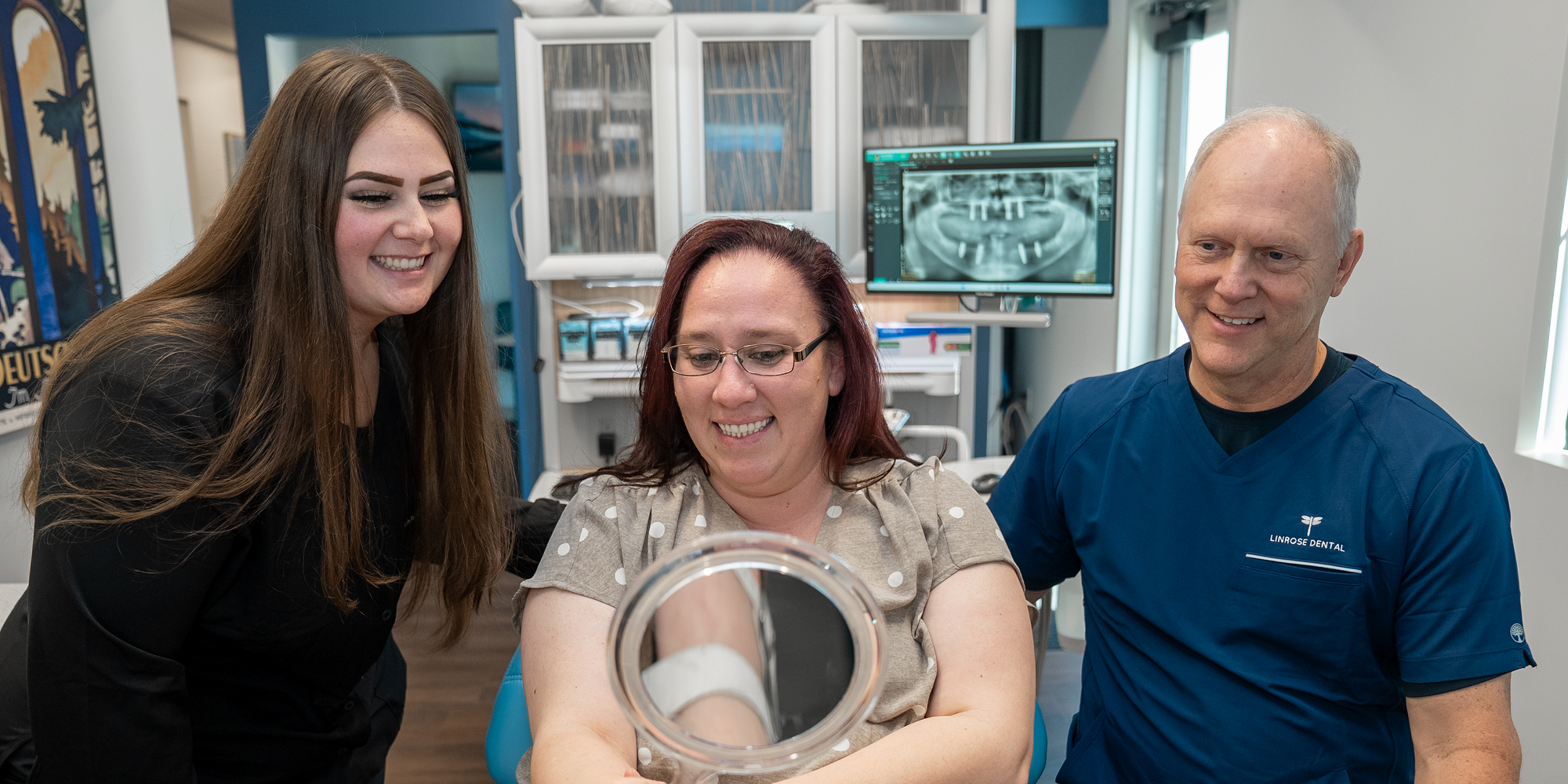 Patient looking into mirror with doctors