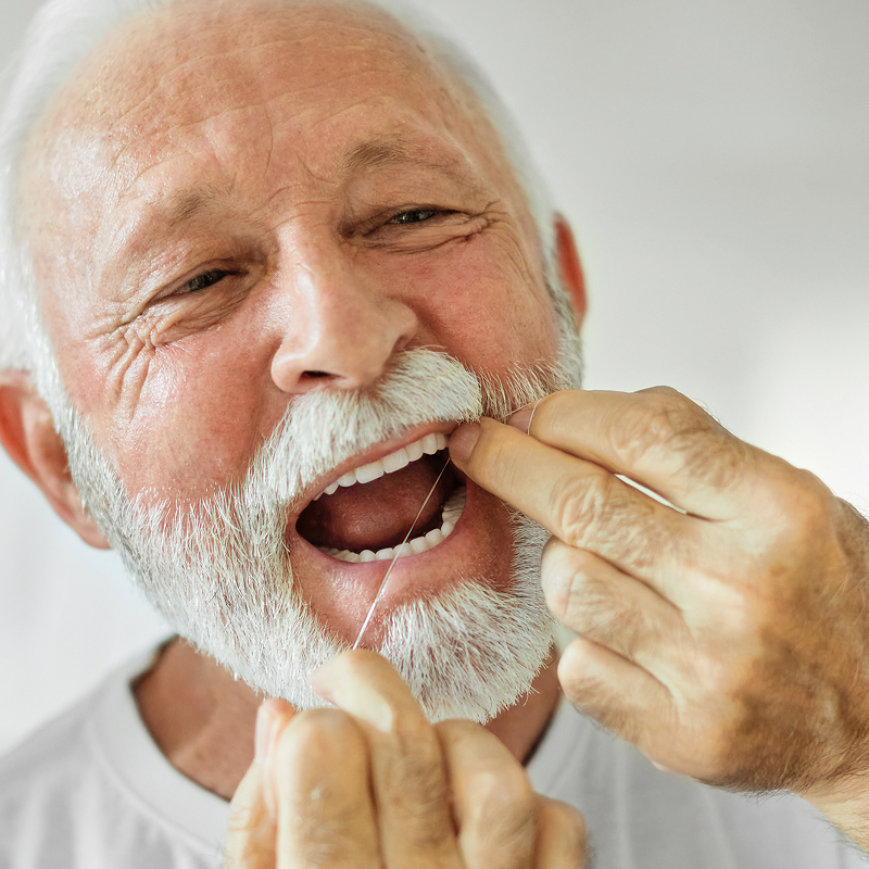 elder man flossing