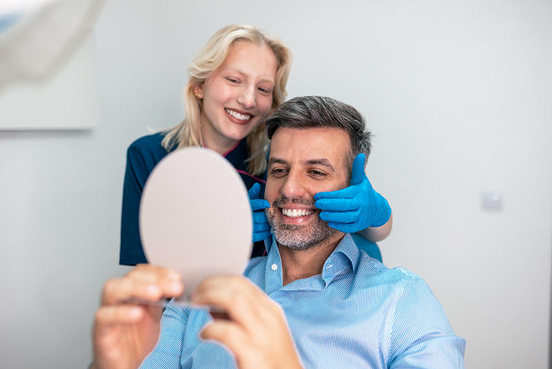 patient looking into mirror after procedure