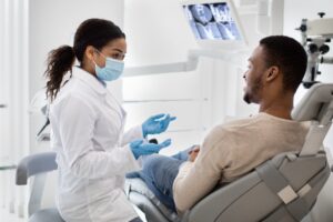 Guy talking to doctor in a dental chair