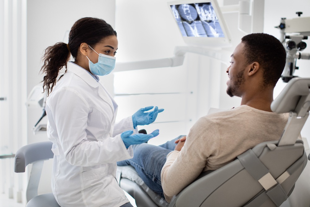 Guy talking to doctor in a dental chair